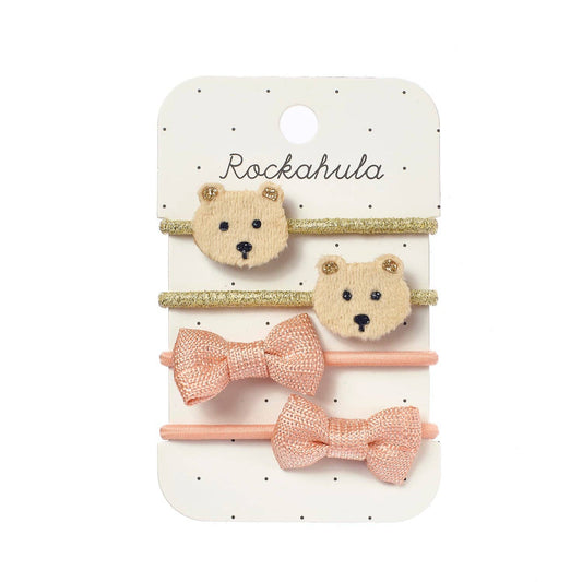 Set of bear-shaped hair clips with pink bows on a Rockahula branded card.