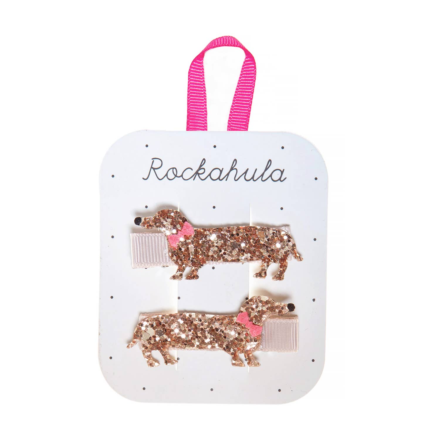 Two glittery dog-shaped hair clips on a 'Rockahula' branded card with a pink ribbon handle.